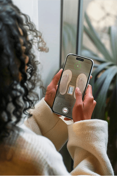 Person scanning feet with phone